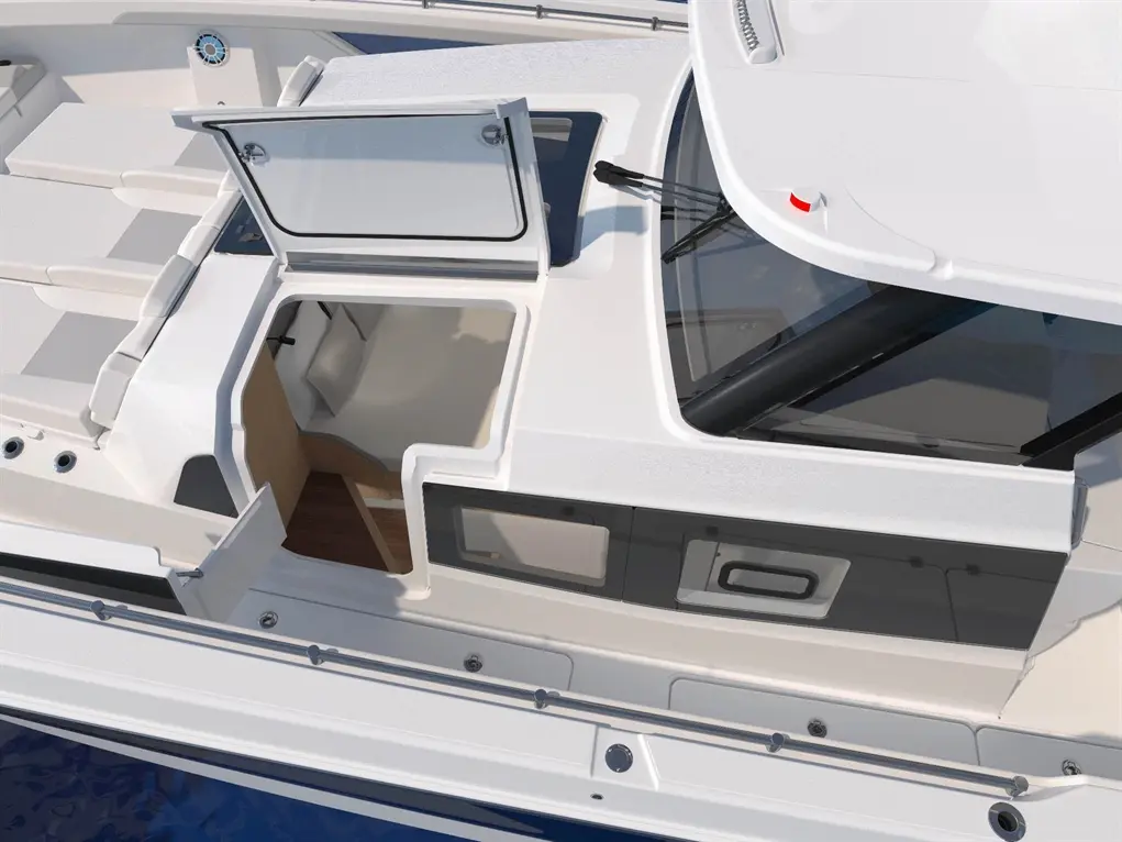 Aerial view of a modern yacht with an open cabin entry, featuring sleek white surfaces and a wooden interior.